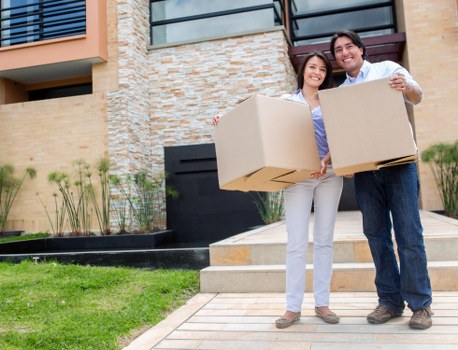 Professional movers loading household items for a South East London move